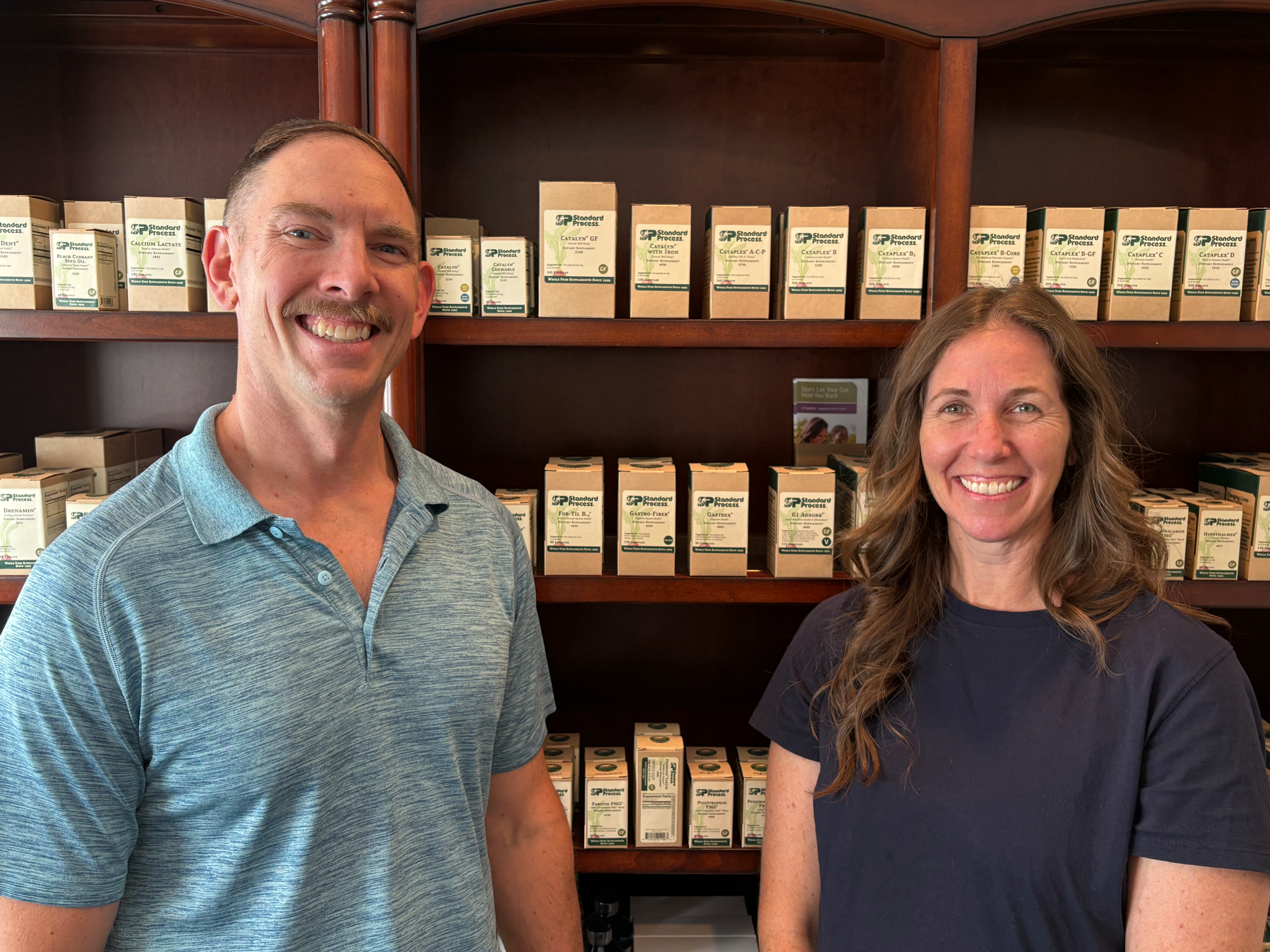 Dr. John and Dr. Shanna Paciorek of Harding Holistics in Springfield, Ohio with Standard Process whole food nutritional supplements in the background