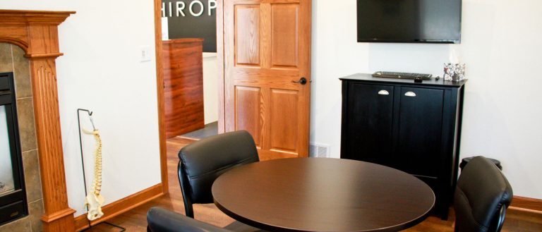 Picture of the office with a table and chairs.