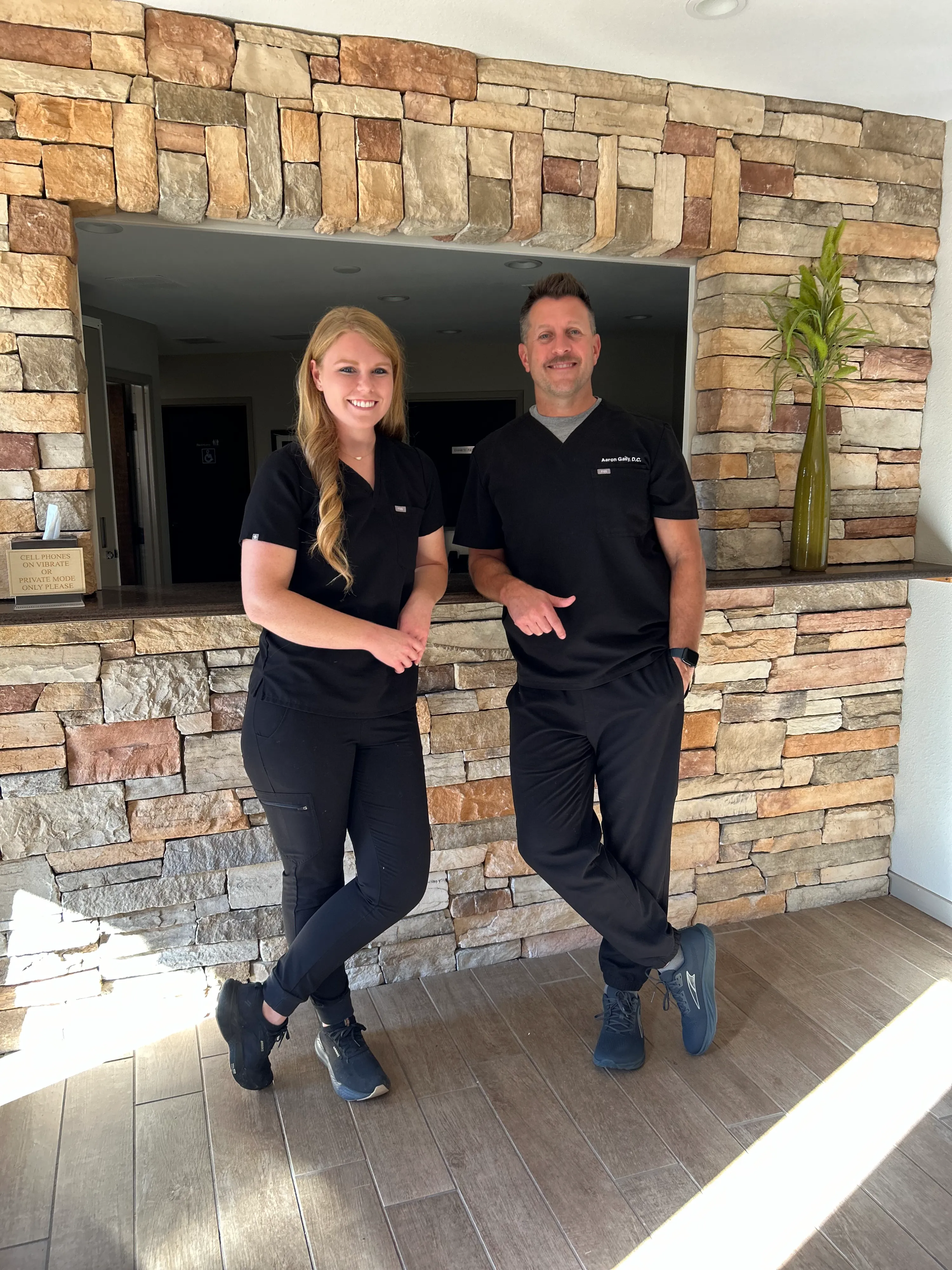 Dr. Aaron Gaily, a leading chiropractor in Monterey, CA, explains a spinal X-ray to a patient during a detailed chiropractic consultation. At The Back and Neck Pain Center, we use advanced diagnostics to ensure personalized chiropractic care for every patient.