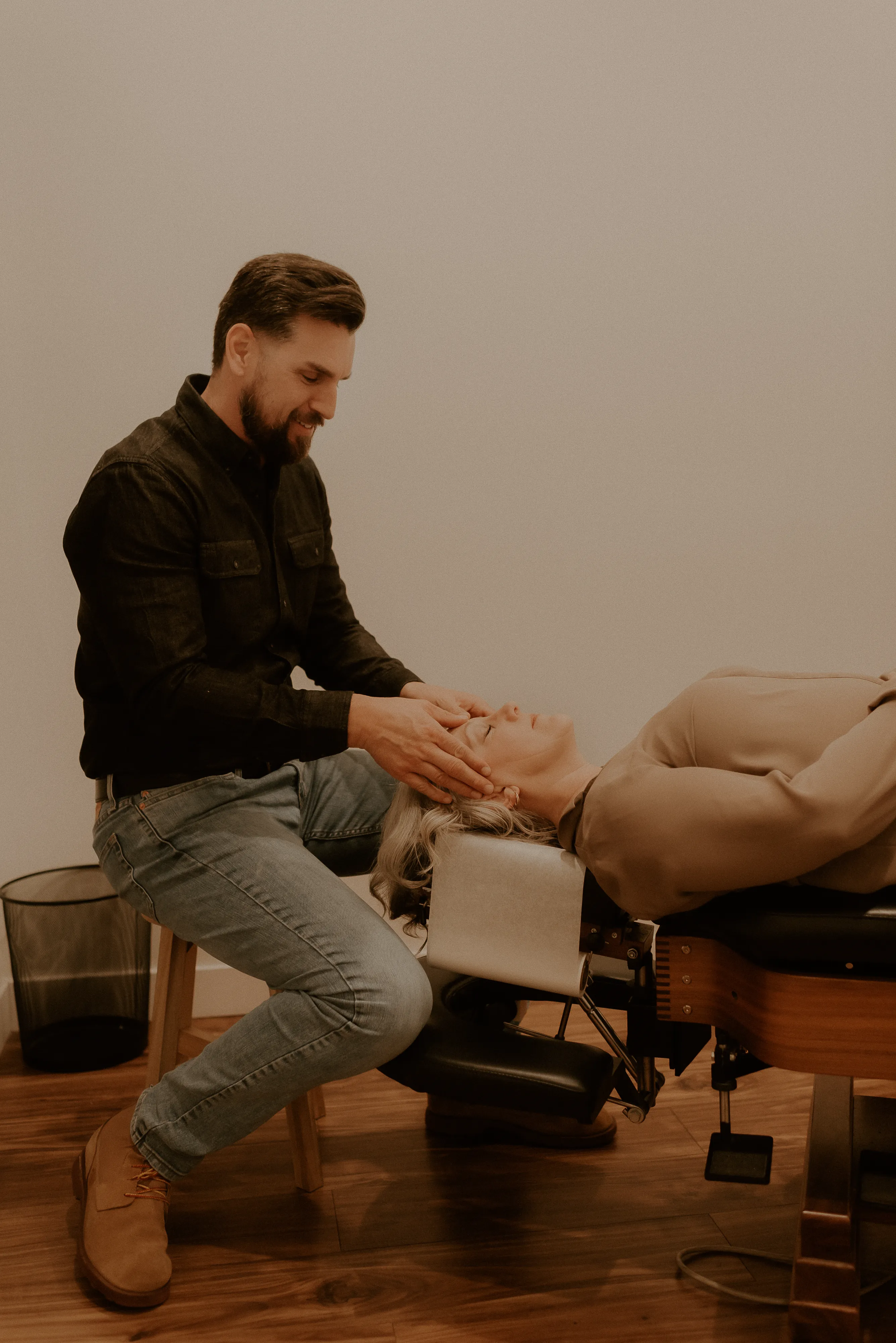 Chiropractor providing an individualized chiropractic adjustment to an adult patient at Rise Chiropractic Co.